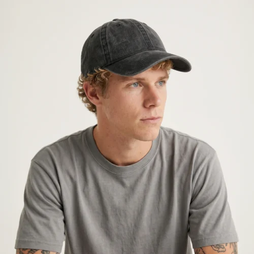 Man wearing dark gray acid wash cap 6 panels.