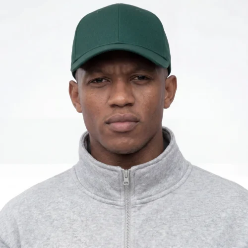 Man wearing a classic dark green twill cap.