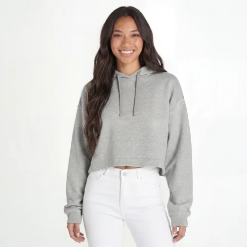 Woman wearing a heather gray cropped hoodie.