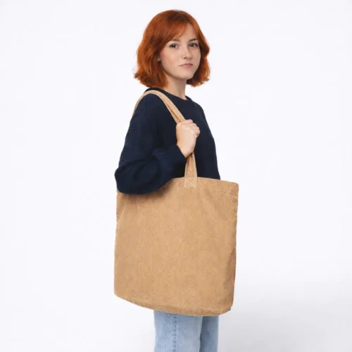 Woman with red hair and a brown bag.